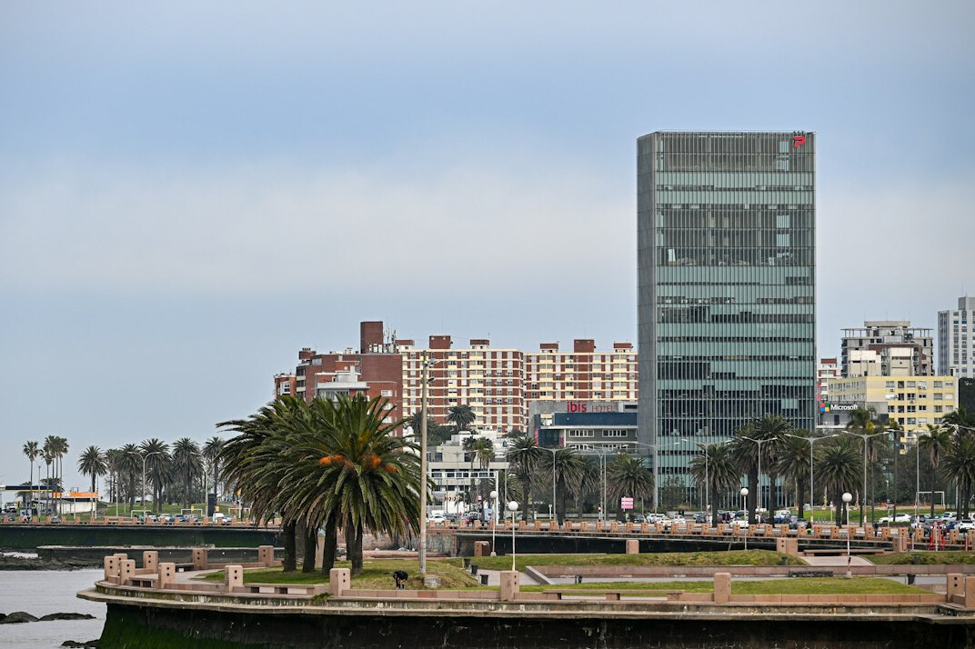 Misty Montevideo rambla waterfront promenade at dawn with empty benches