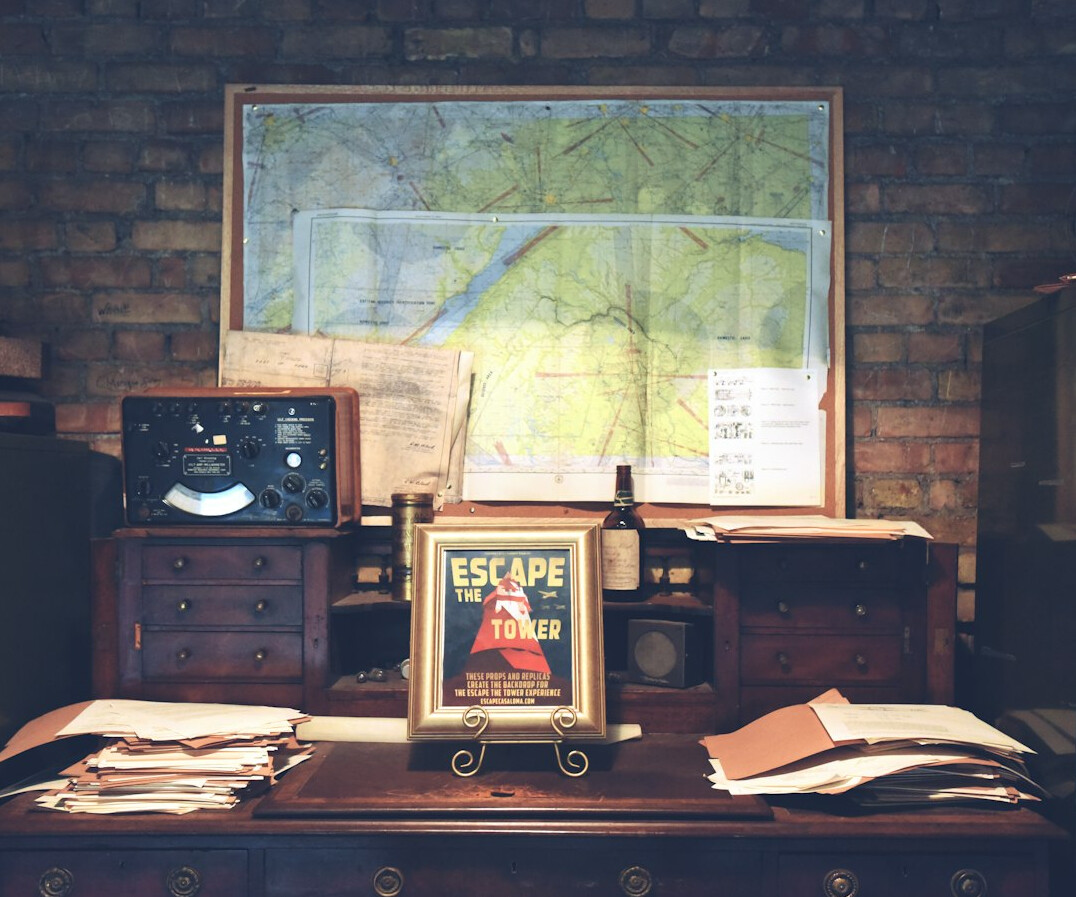 Investigator's desk with a city map, pinned notes, coffee cup and case documents
